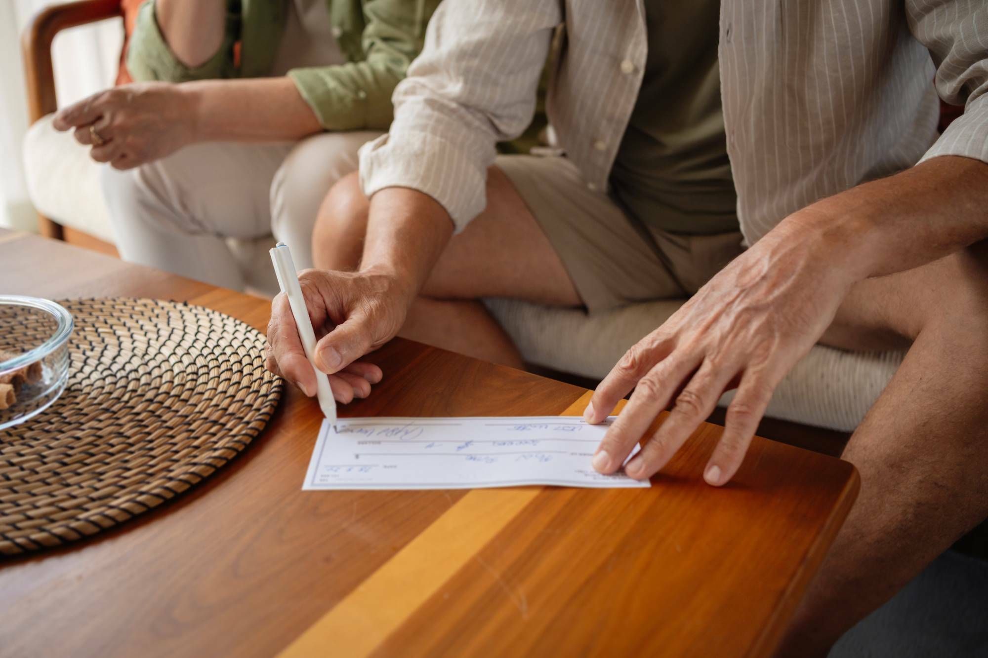 Man writing an earnest money deposit check