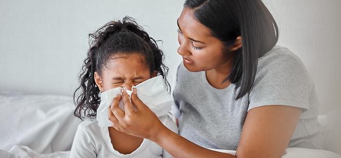 a child and her mother are both in bed sick