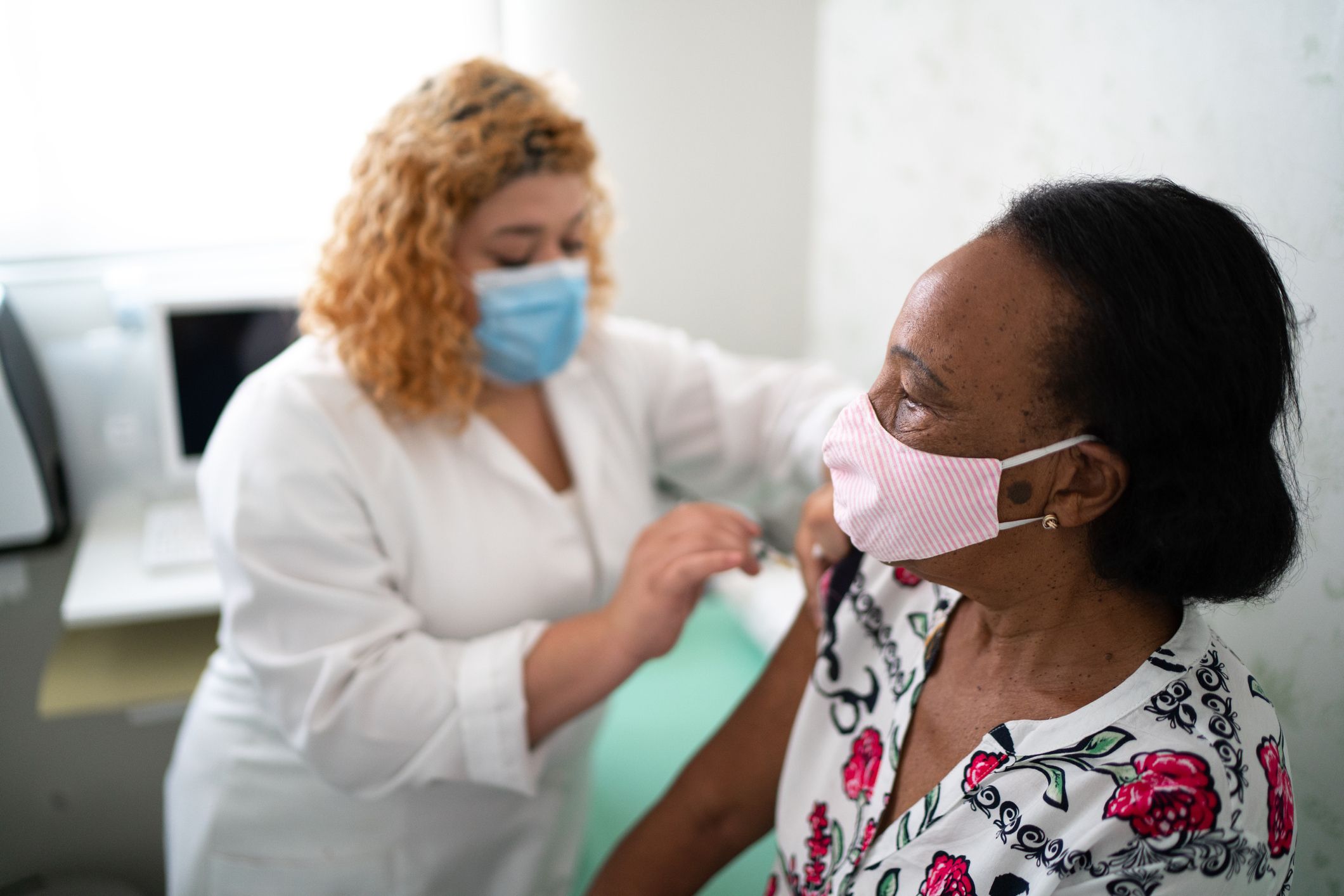 woman getting a flu shot from a nurse at medhelp urgent care clinic in birmingham