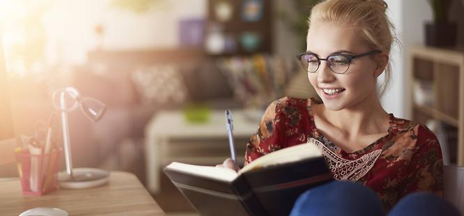 Woman writing in calendar to get her flu shot