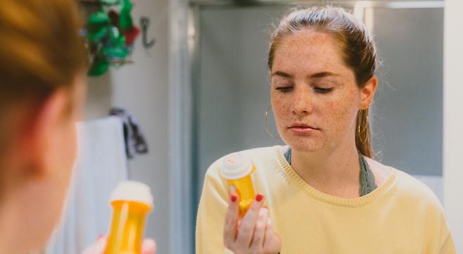 woman at home asking questions about prescription from primary care doctor