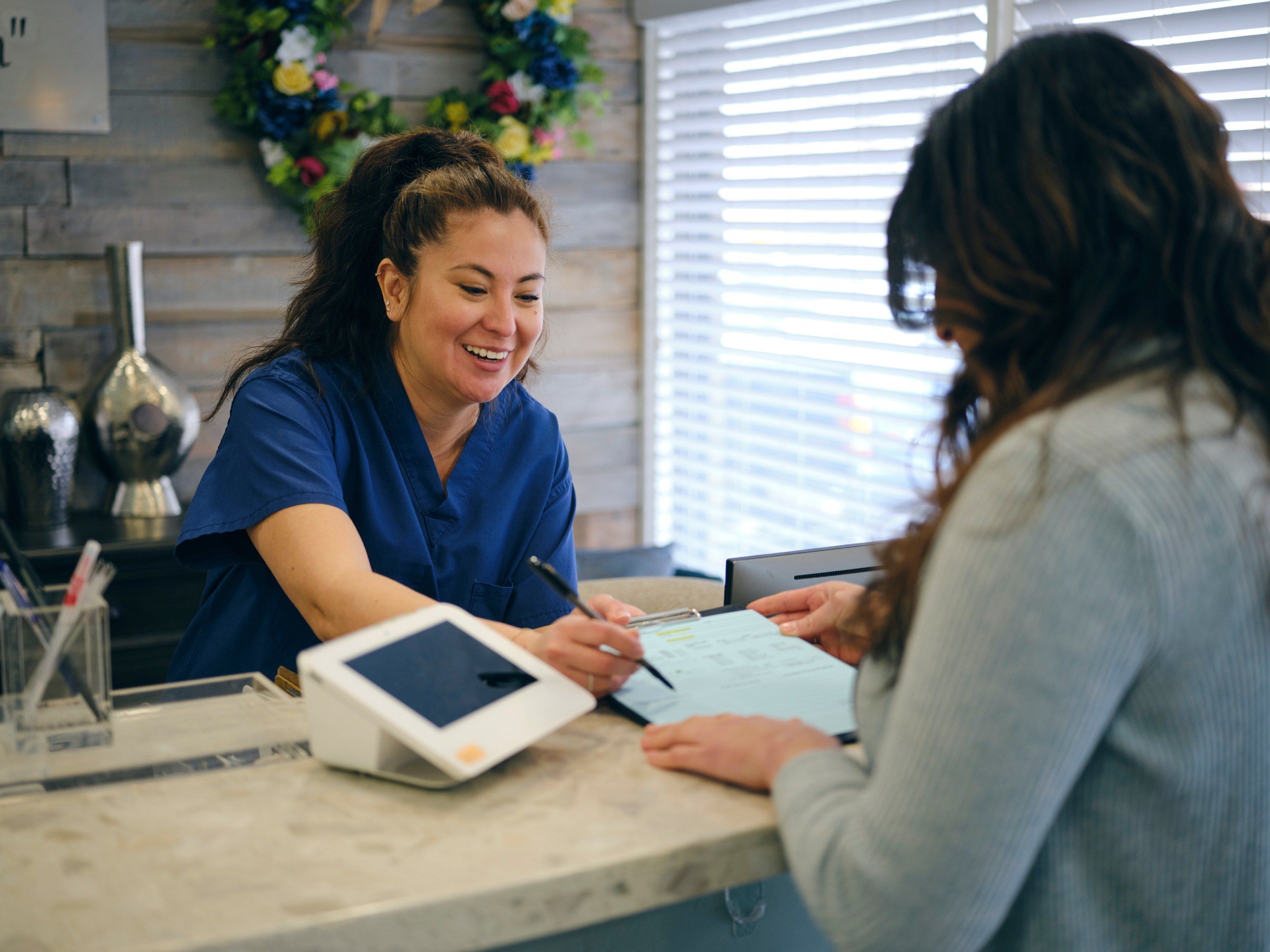 Person signing papers at medical checkin