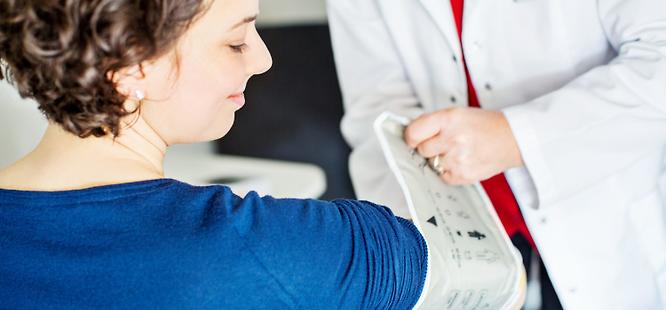 Woman getting blood pressure checked