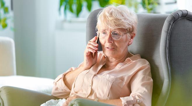 senior woman talking on the phone with medhelp telehealth virtual doctor appointment