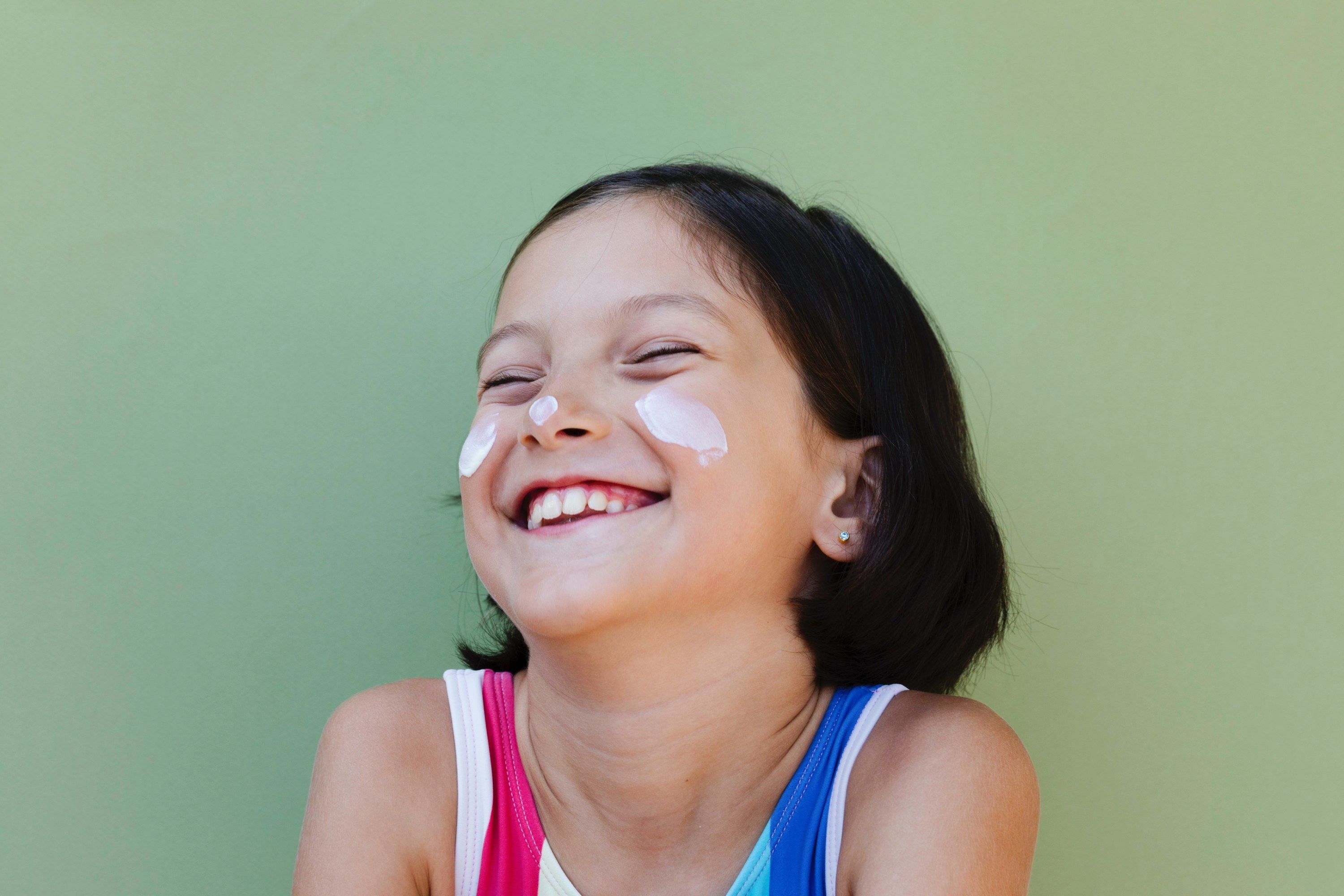 Girl with sunscreen on face
