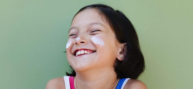 Girl with sunscreen on face
