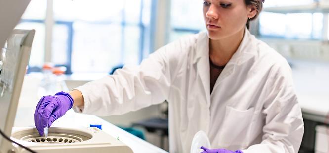 Lab tech running samples at medhelp