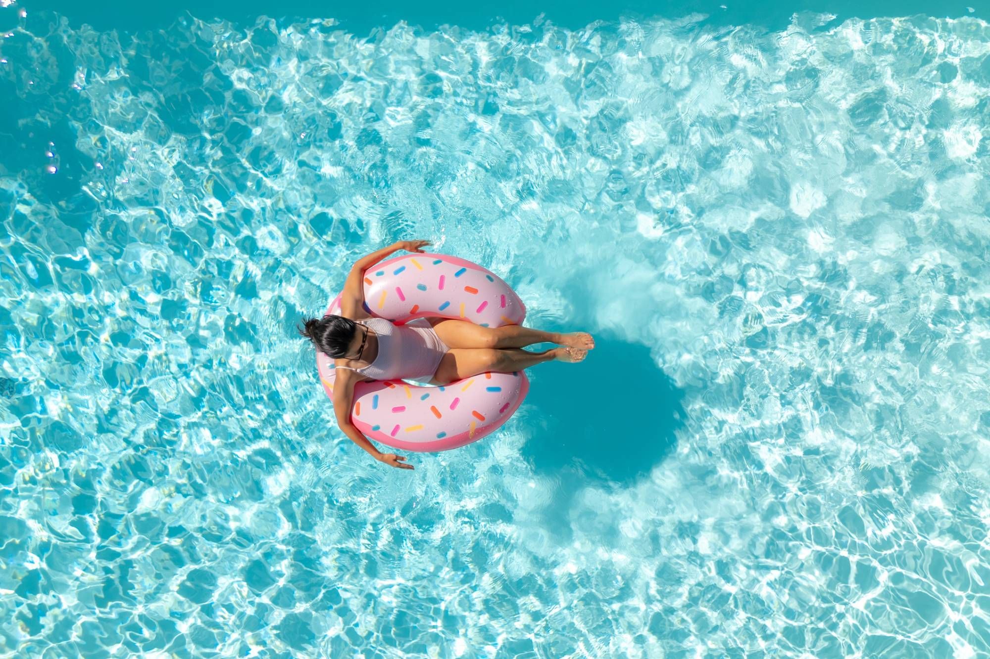 Woman floating in the pool in alabama