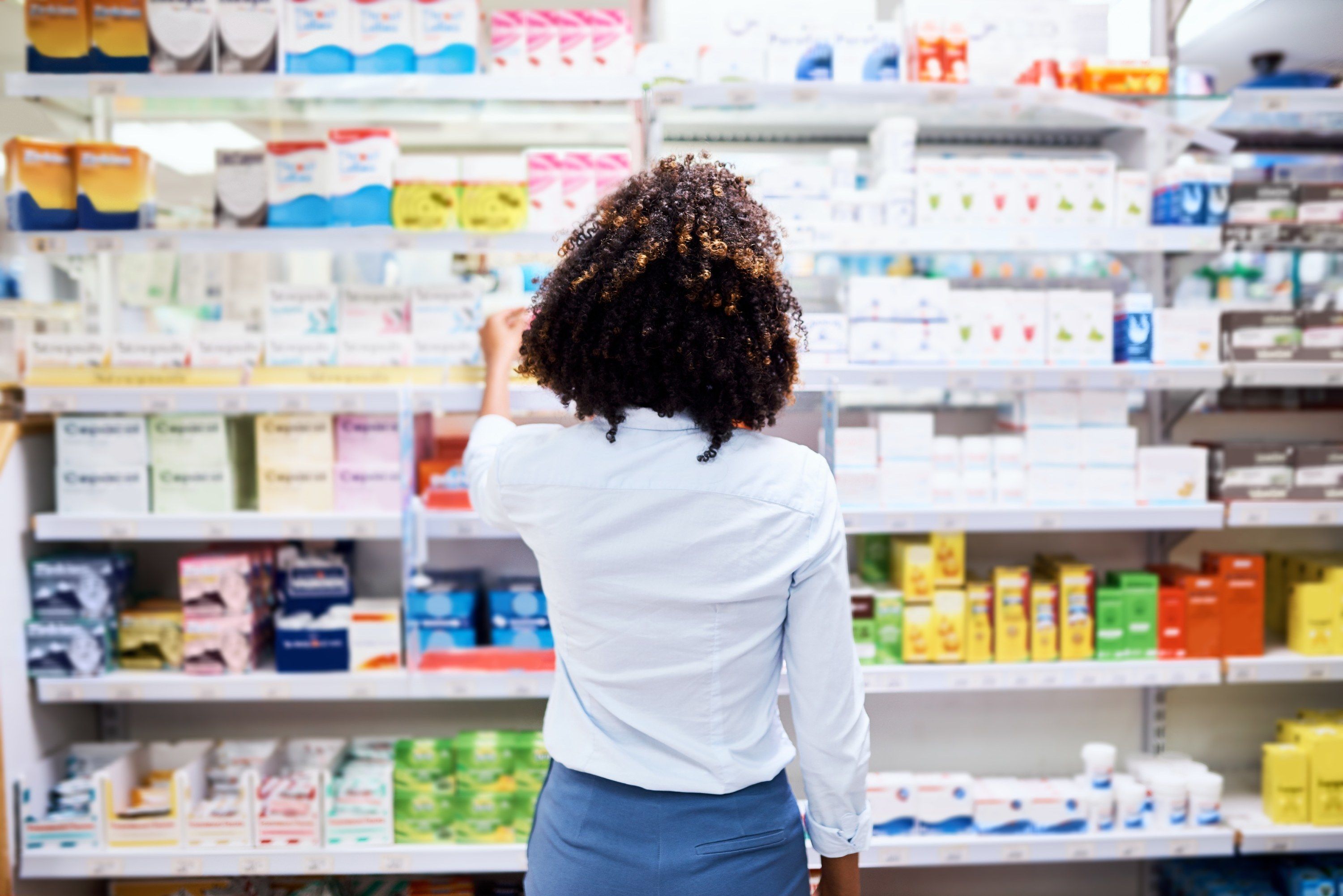Woman looking at medicine and antibiotics
