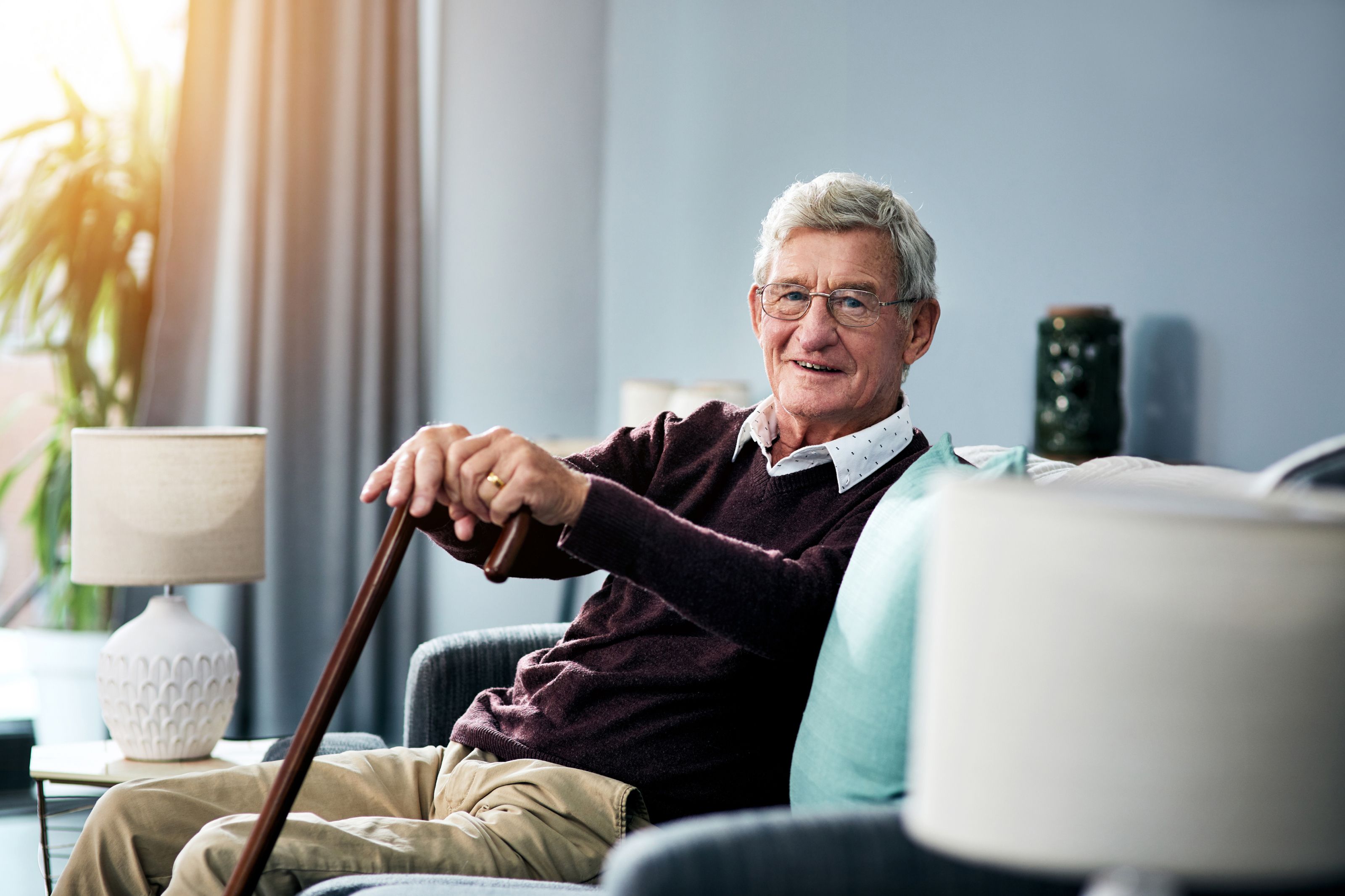 elderly man sitting with cane receiving medicare chronic care management with home monitoring