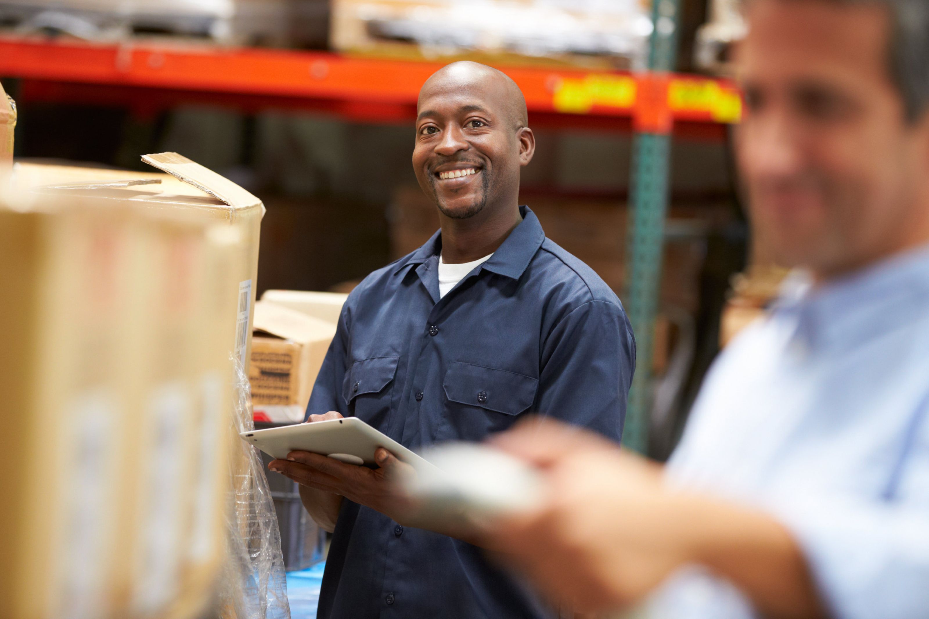 smiling man working at warehouse receiving occupational health services