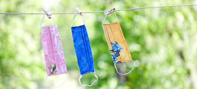 three cloth masks drying on a clothesline protecting from covid-19