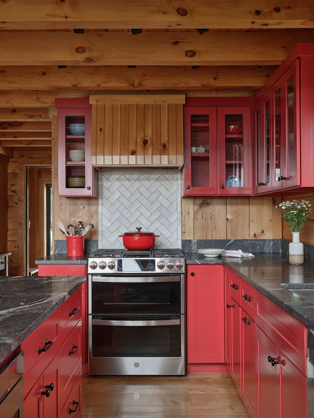 Kitchen remodel at Sanctuary Camp featuring Vining’s Custom Cabinets. Glass-front upper cabinets keep the small kitchen feeling open and airy.