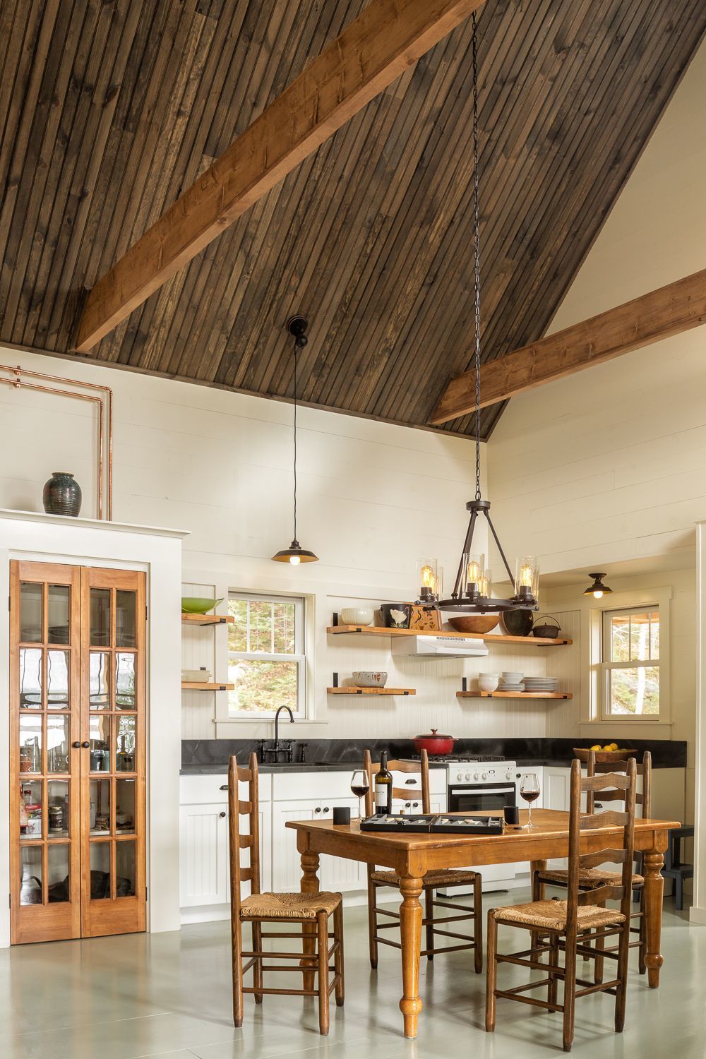 Custom built-in pantry with French glass doors and crown detail at Cliff Cottage