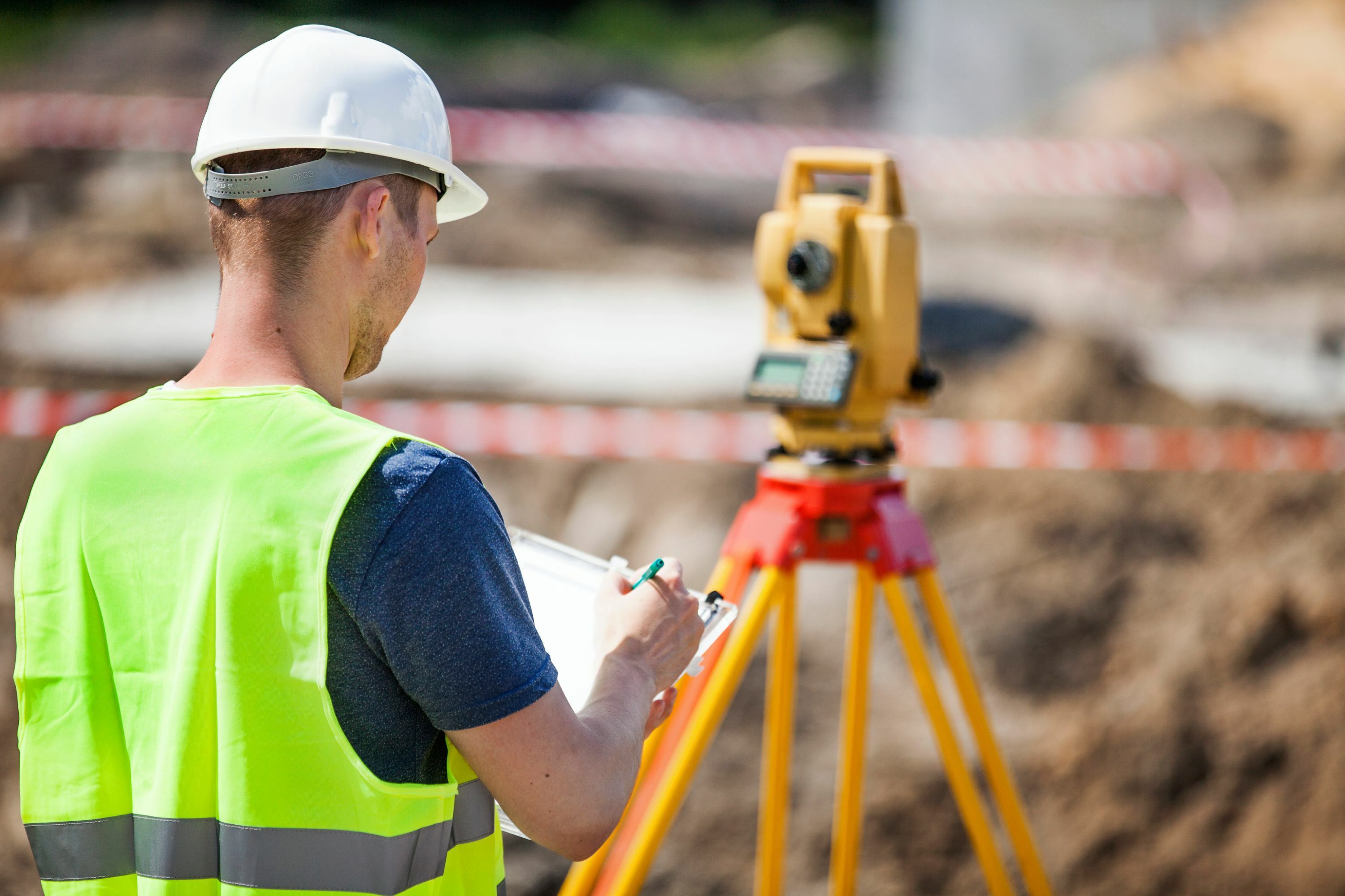 Man performing survey for title insurance