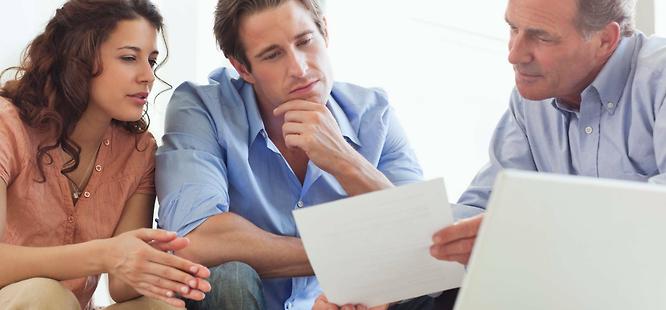 Realtor and clients discussing title insurance