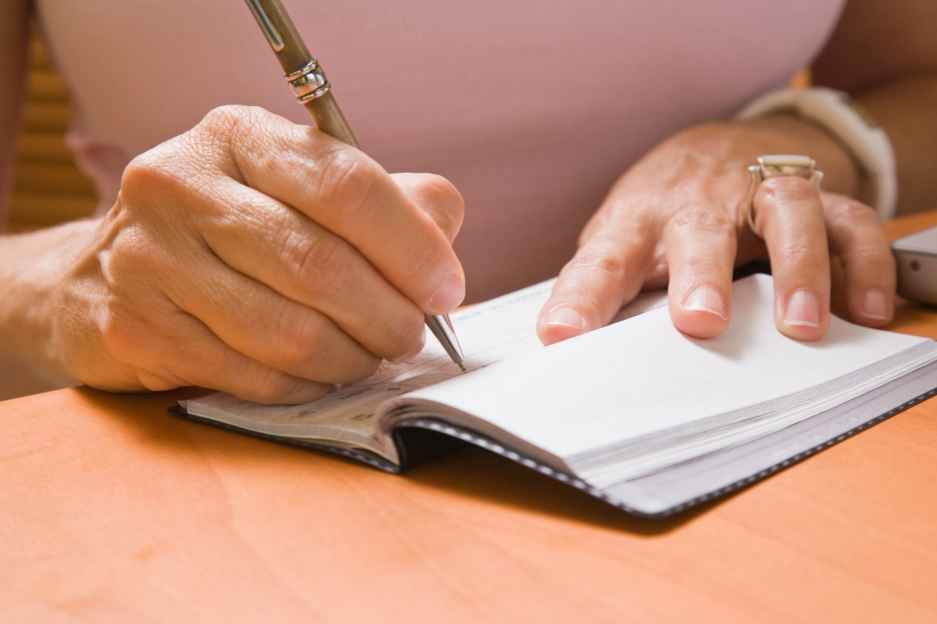 Woman signing an earnest money check