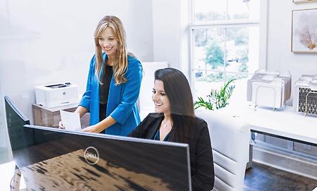 two women performing a title search and exam at south oak title and closing