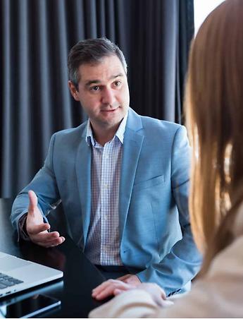 closing attorney in blue suit jacket helping a female client close on her home at south oak title